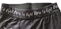 Close-up of black spats waistband with Born to Fight text print
