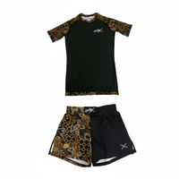 Batik-X Inferno short sleeve rashguard and matching fight shorts set, black compression top with yellow and brown batik design, designed for BJJ and MMA.