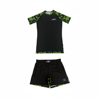 Batik-X Pulse short sleeve rashguard and matching fight shorts set, black compression top with green batik accents, designed for BJJ and MMA.